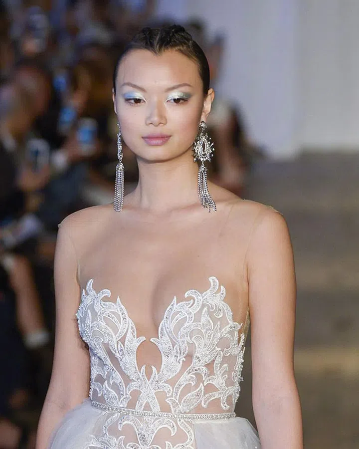 At Berta, bold beauty was the name of the game. A Balmain-inspired extra-long and braided ponytail wasn't even the most eye-catching piece of the look. We can't get over how fun a chrome eyeshadow, laid on thick from lashline to just above the crease, looks when paired with a nude lip and statement earrings.