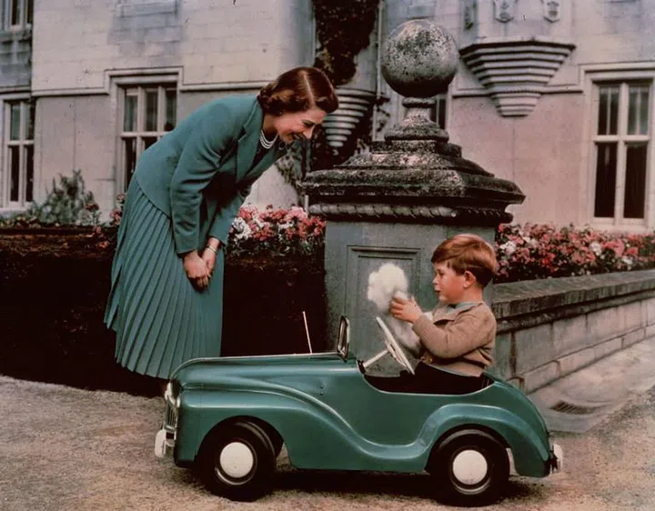 Prince Charles had a toy car of his own. Here, Princess Elizabeth watches him in it at Balmoral. 