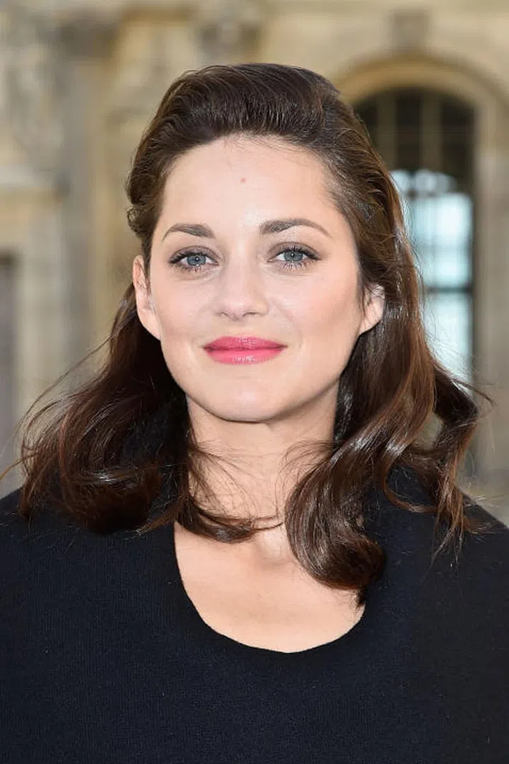 Instead of parting hair down the center, try sweeping all of your hair back with a hair-clip and teasing at the roots. Photo: Getty