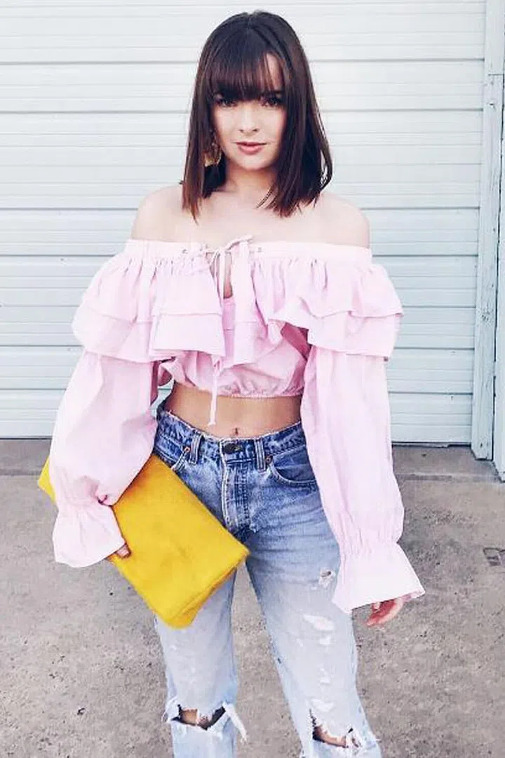Keep eye-skimming bangs looking polished (like blogger Jane Aldridge here) by rounding them ever so slightly with a flat iron. Photo: Instagram @seaofshoes