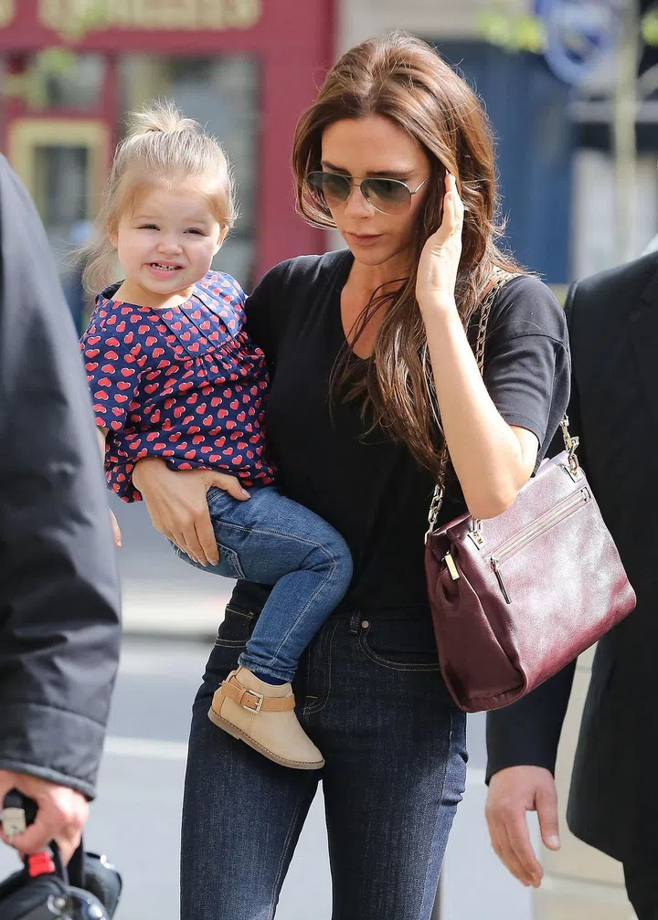 VB left her brood of three boys at home and totted her baby daughter like her favourite accessory
