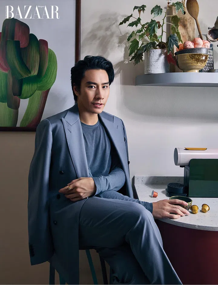 Wearing a suit by Suit Supply, Hong enjoys a cuppa at the coffee bar in his kitchen.