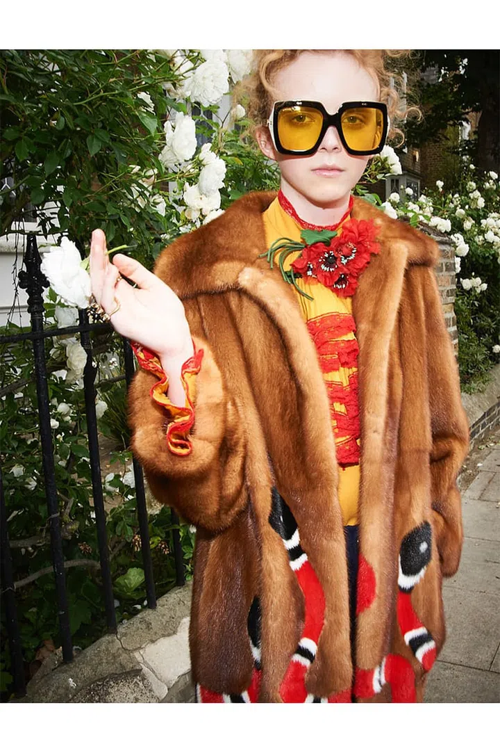 Fur coat; silk and lace dress; acetate sunglasses; silk floral brooch; metal rings, Gucci.