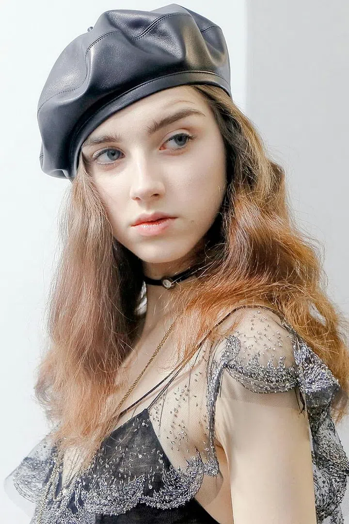 Hairstylist Guido Palau brought back an old school hair technique for the Dior show. Palau and his team coiled the hair in paper towels, baked them with a flat iron, and then brushed through each curl to get the fuzzy bends. "It gives a much softer feel than a curling iron, and of course you get the volume in the hair," says Palau. Other than shampoo and Redken Wind Blown 05 Volumizing & Texturizing spray, no other product was used. "There's this lightness that comes from this very clean hair," he says. "It's soft and floaty and very easy."