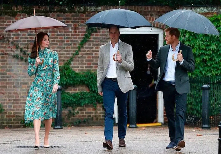 Kate, William and Harry walk through The Sunken Garden at Kensington Palace, a favorite spot of Princess Diana's. Photo: Getty
