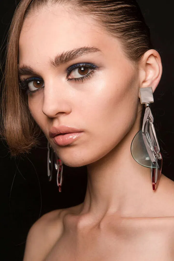 Navy eyeshadow was smeared across the top lids at Giorgio Armani, while traces of black eyeliner were traced along the bottom lashline. 