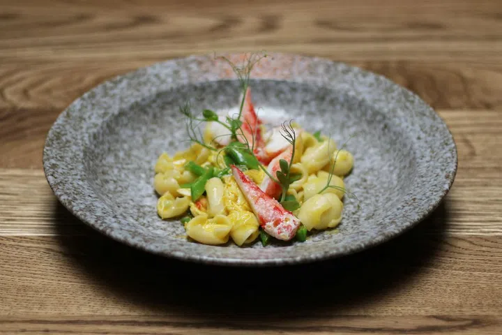 King crab orecchiette pasta served with a thick
saffron and corn sauce. Topped off with
sugar snap peas and fresh basil. The
sweetness of the crab is paired with earthy pea
flavours.

Photo: Courtesy of Open Door Policy