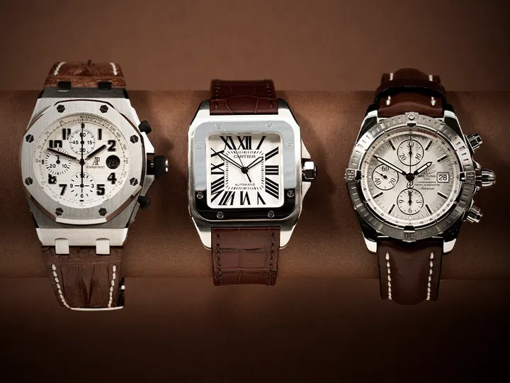 stainless steel audemars piguet royal oak watch, cartier santos watch and breitling watch with brown leather strap