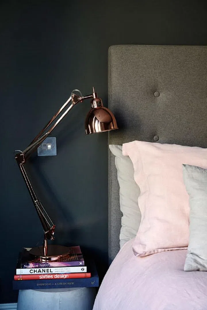 An ingenious way to get the most out of your small space is to use items that can double up as something else. Pile up books neatly on a stool and place a lamp or vase on top. This functions as both book storage and a side table, and shows off your literary prowess at the same time. Tip: the bigger and chunkier the books, the better. Photo: FLAT15