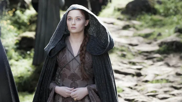In a sea of intricate twists and braids throughout the series, a simple side plait under a travel-worn hood is indeed refreshing