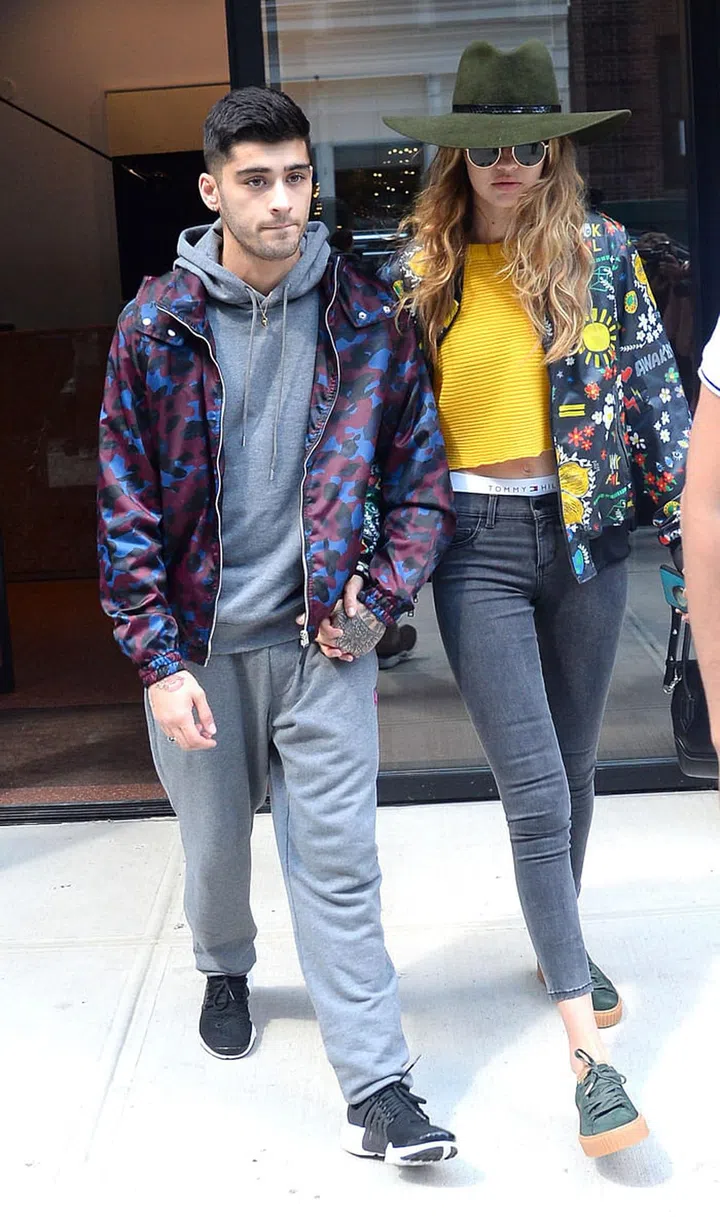 In an Adidas Originals by Pharrell Williams jacket, Puma x Fenty by Rihanna creepers, a yellow cutoff shirt, Tommy Hilfiger briefs and black skinny jeans. Hadid topped off the casual look with a forest green floppy hat, rounded specs and arm candy – her rockstar boyfriend Zayn. Photo: Getty