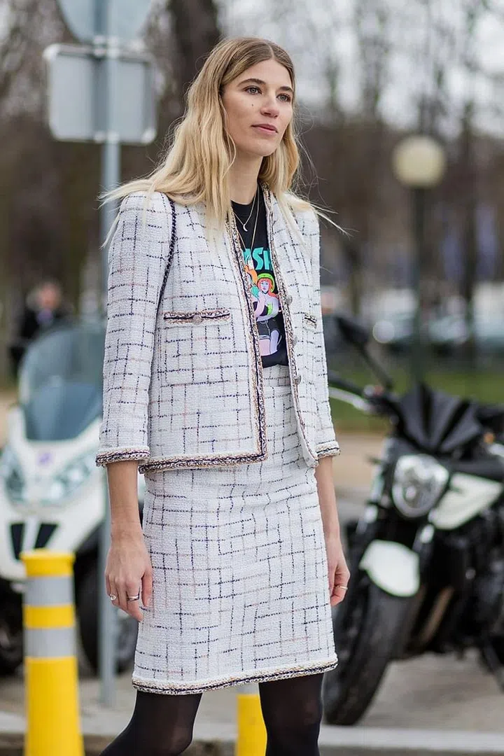 Coco Chanel designed the tweed skirt suit as a way of freeing women from the restrained cinched-in silhouettes of the 50s. Still widely desirable today, the look is still sported by diverse high-profile women from Veronika Heilbrunner and Alexa Chung to Vanessa Paradis and Kendall Jenner.