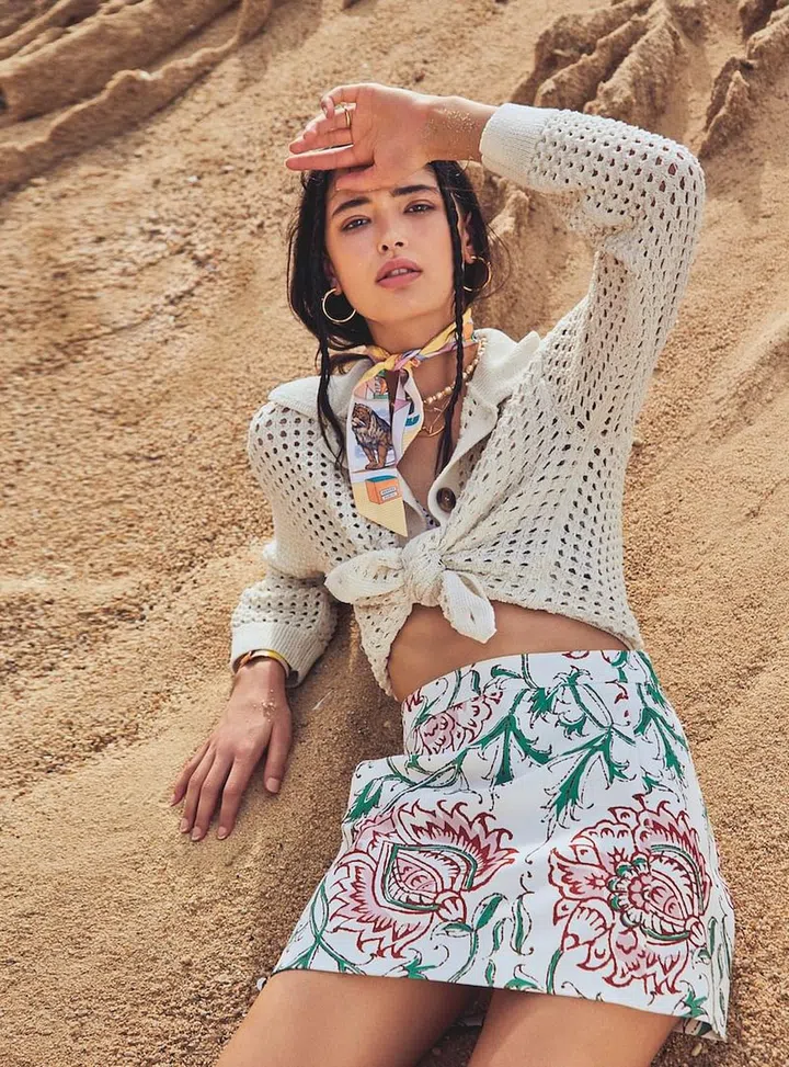Skirt, Longchamp. Cardigan, H&M. Ring, Kate Spade New York. Earrings, Chanel. Scarf; bangle, Hermès. Pearl necklace, Valentino. Necklaces, Louis Vuitton. Bikini top, stylist’s own. Necklace, model’s own. (Photo:  Phyllicia Wang)