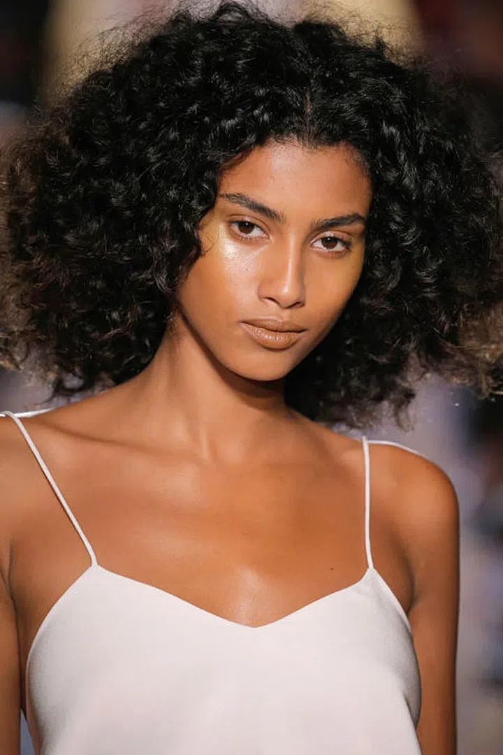 At Brandon Maxwell, makeup artist Tom Pecheux spread a gold pigment across the models' cheekbones to give the illusion that they were sweating gold.