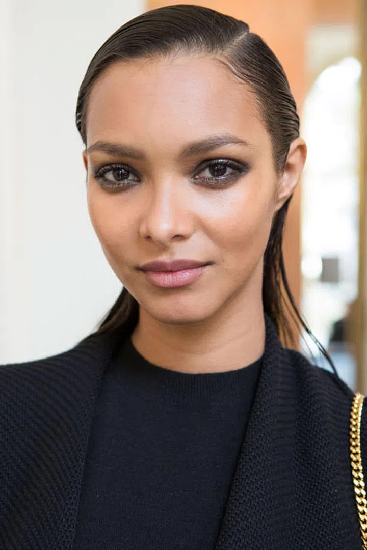 Makeup artist Tom Pecheux dabbed an eye gloss on top of eyeliner and shadow to create the smudgy effect backstage at Balmain.