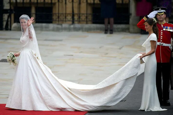 Kate Middleton steps out in a custom lace applique dress by Sarah Burton at Alexander McQueen, a silk tulle veil, and the Cartier 'halo' tiara.
Photo: Getty
