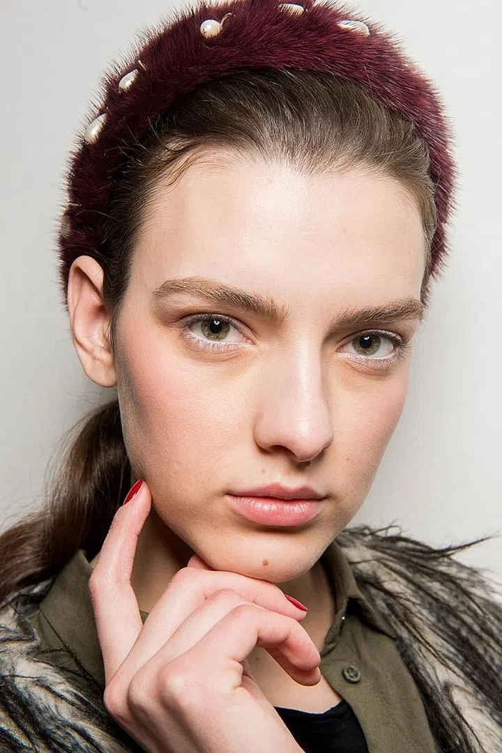 Bits of colorful string were braided throughout the hair backstage at Maison Martin Margiela (not unlike the kind you wore on that cruise when you were a child). 