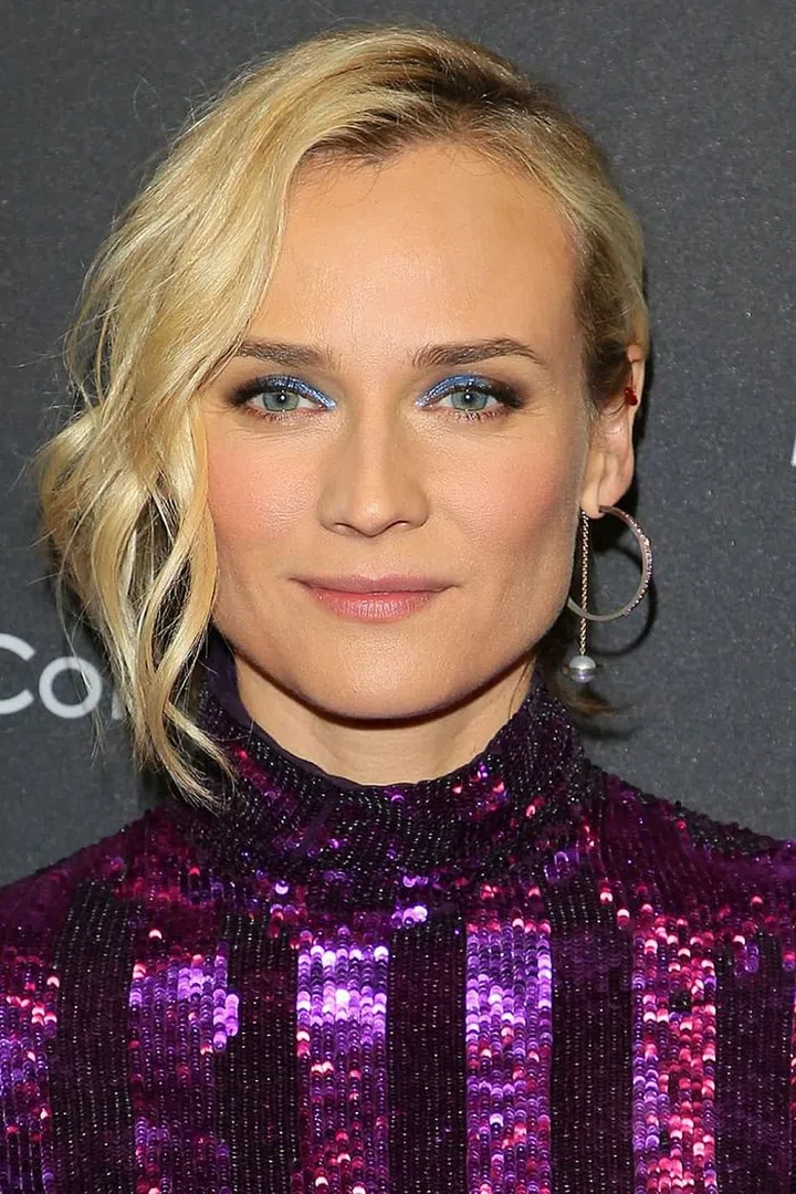 A pop of sparkly blue eyeshadow lends a party-ready vibe without going overboard.