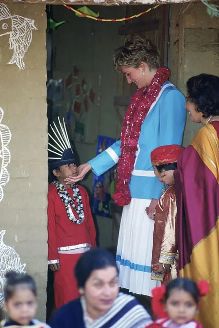 Playing with children during a visit to The Tamana Special Needs Nursery School In Delhi, India.


