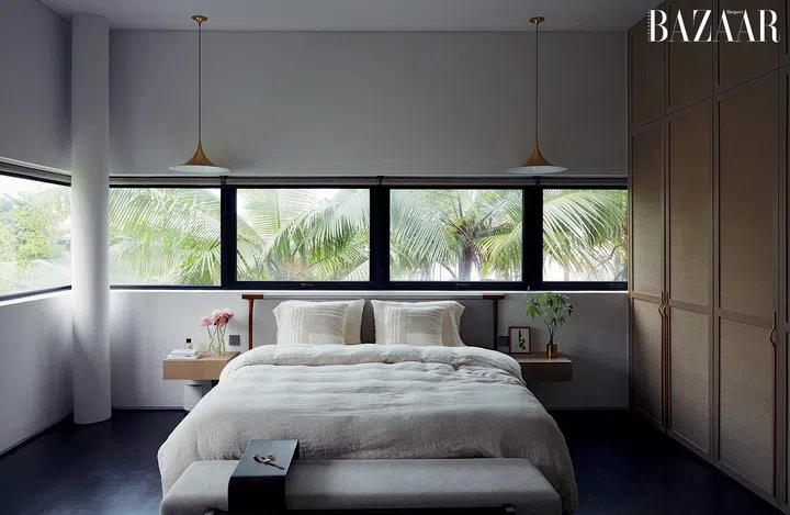 Her bedroom evokes a calming aura, thanks to views of greenery and neutral bedding in soft textiles.  The custom cabinetry was crafted with Phillip Jeffries wallpaper, bleached teak wood and electroplated stainless steel handles. Photo: Gan