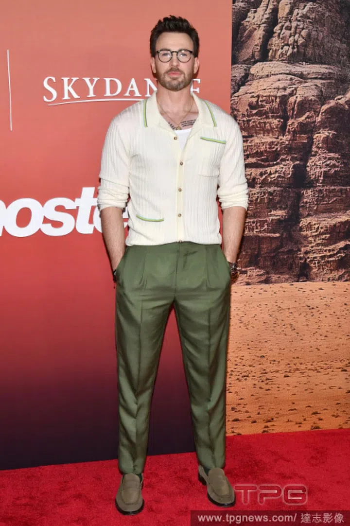 Chris Evans in a cream knit that subtly clings to his body.