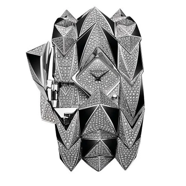 The punk-inspired rough look Diamond Fury by Audemars Piguet features a staggering 3,246 brilliant cut diamonds and 56 black onyx elements with an additional 206 brilliant cut diamonds on the covert watch dial. Flipping over a stud reveals the hidden timepiece, an added luxury to an already mind-blowing white gold cuff.
Price Upon Request, audermarspiguet.com