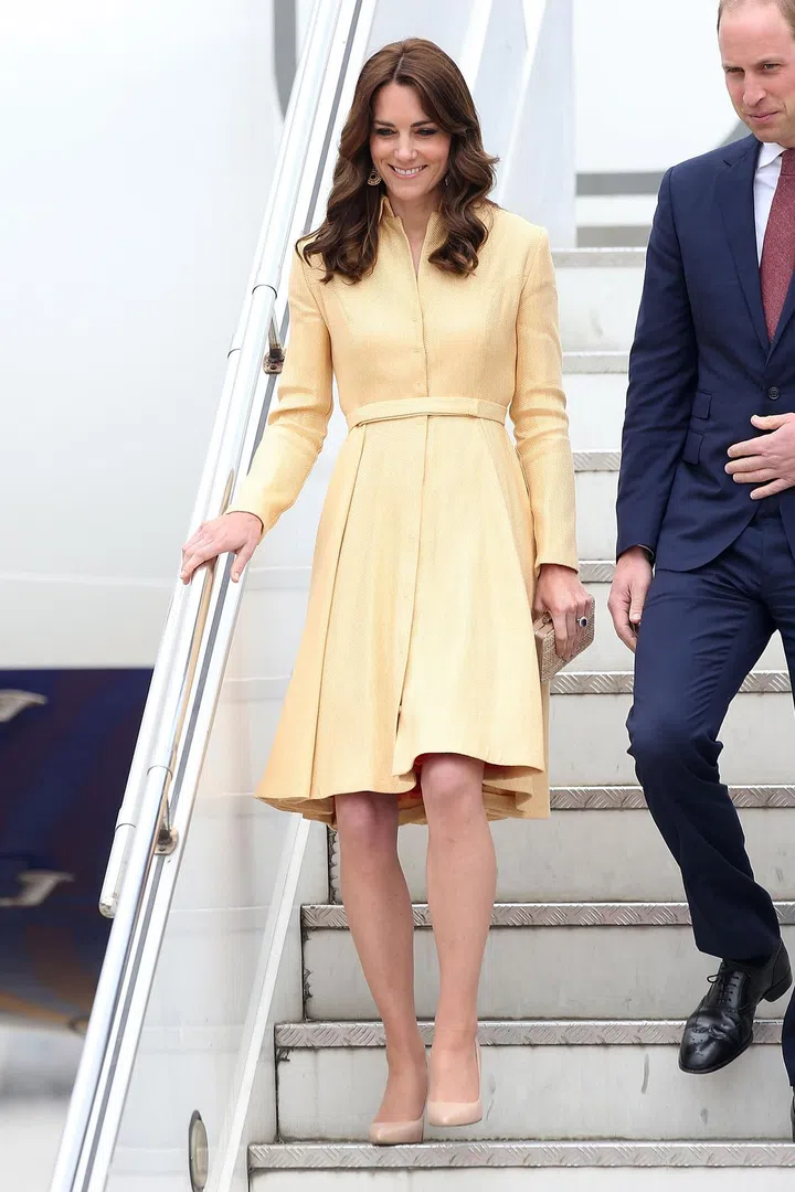 The duchess sports a clean cut pastel yellow dress while arriving at Paro International Airport in Bhutan.