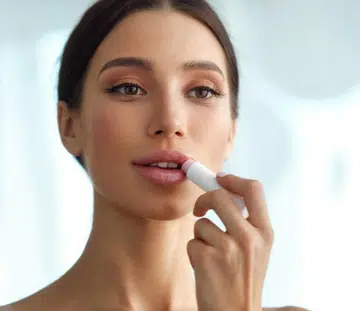 woman applying lip balm