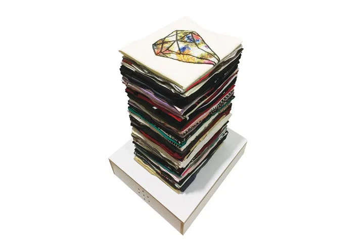 “Gunny Stack is a representation of fashion in Singapore. It consists of clothes donated from Singaporeans, folded neatly to mimic a stack of newspapers for recycling. Fashion shares so many qualities with newspapers; it is meant to be attention-grabbing, is mass produced and ephemeral. The voice of the karang guni reminds us that even the latest fashions are destined to be discarded.”