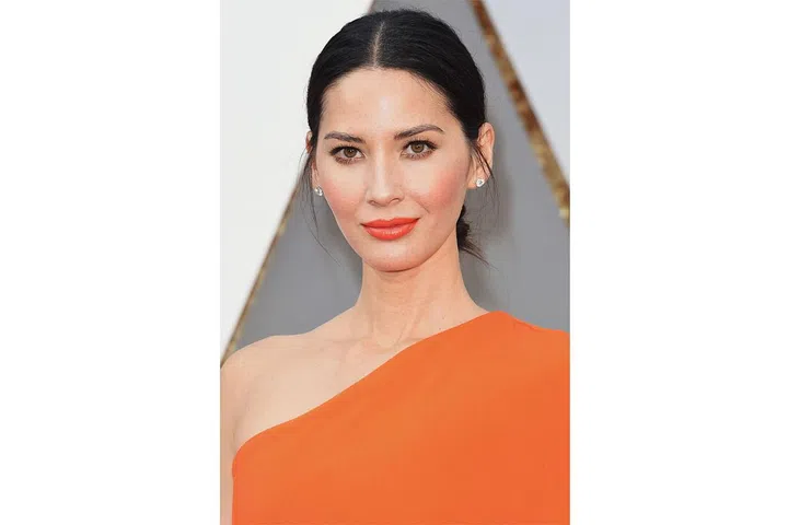 Olivia Munn works her tawny complexion with a fiery orange Stella McCartney dress complete with precisely applied peachy blush and a juicy coral pout – talk about a one-colour statement! 