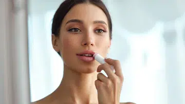 woman applying lip balm