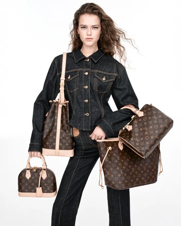 Model in Louis Vuitton denim look carrying the Monogram Origine bags in Alma, Noe, Neverfull and Speedy styles.