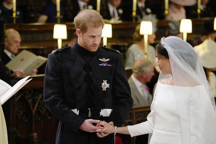 Prince Harry taking Meghan Markle's hand