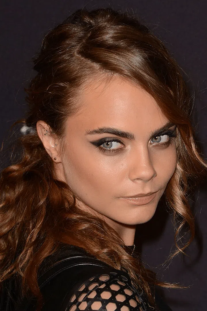 A curled low ponytail with an intense cat eye - feminine with an edge.