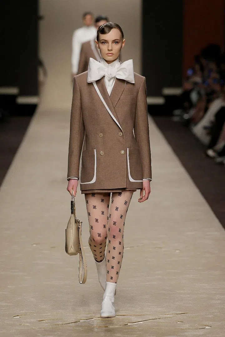 Karl Lagerfeld’s final Fendi collection was filled with plenty of the signatures he established over five decades at the Roman House. Structured pagoda shoulders, rigorous tailoring and starched high collars were all hallmarks of his precise hand, and when paired with scarlet lips, shellacked hair and A-line skirts, effortlessly evoked ’40s Hollywood glamour. Lagerfeld made the looks resonate for today by grounding them with pointytoed boots; adding brilliant jolts of colour such as aquamarine and the iconic Fendi yellow; and layering pieces over stockings and bodysuits covered in double-F Karligraphy— guaranteed collectibles and street-style bait. Perforation, see-through layers and swishing pleats added further touches of lightness and modernity.