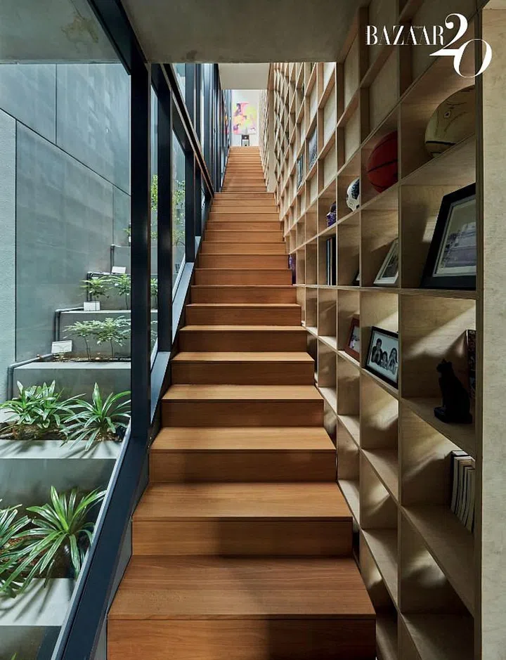 Stairs flanked by edible greenery on one side, and books and artwork on the other.

Photo: Phyllicia Wang