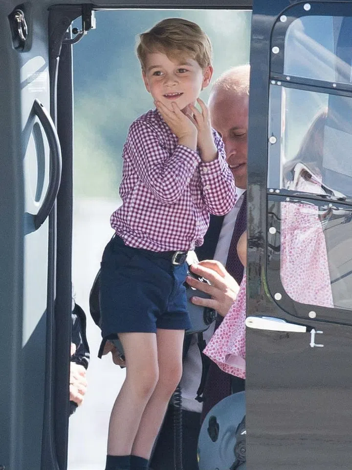 Prince George is excited during his tour of helicopter models on the last day of the royals' official visit to Poland and Germany.