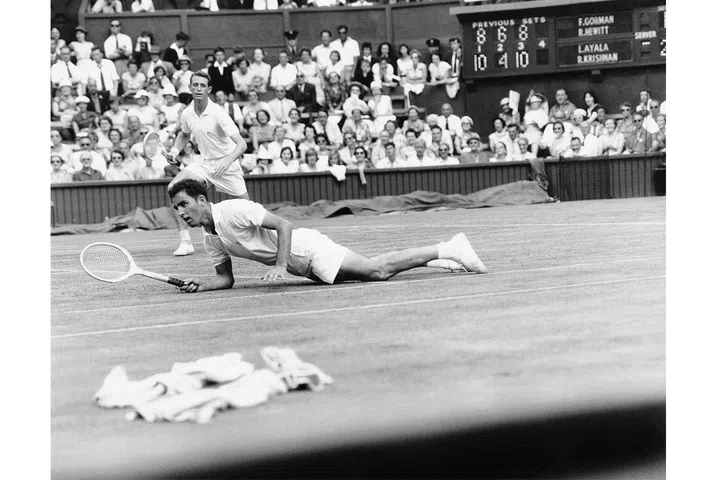 Frank Gorman looks on as his partner Bob Hewitt falls during a Men's Doubles match at Wimbledon. Photo: Getty
