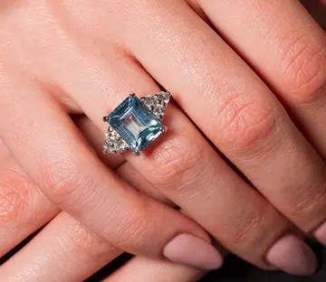 coloured gemstone engagement rings | aquamarine on women’s finger