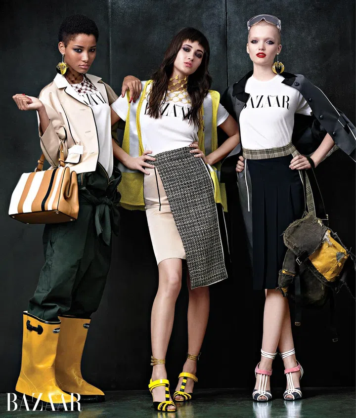 On Lineisy: Prada jacket, earring, neckpiece, and bag; Dickies jumpsuit; On Greta: Prada skirt, apron, neckpiece, and shoes; On Rush: Prada jacket, skirt, apron, earring, and shoes.