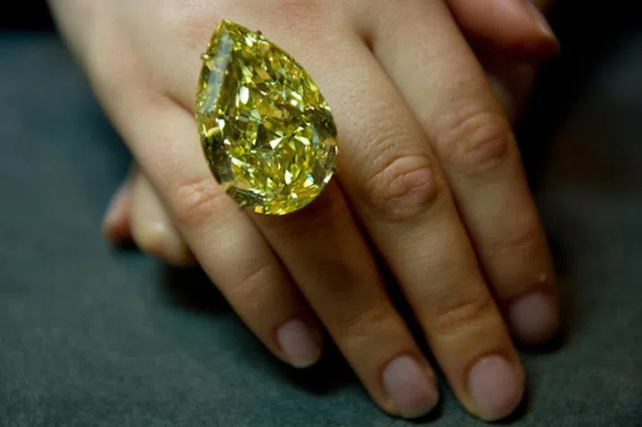 The 110.3-carat pear shaped yellow diamond originated in South Africa and broke records for the most expensive yellow diamond ever sold when it brought in between $10.9 million and $12.4 million at a Sotheby's auction.