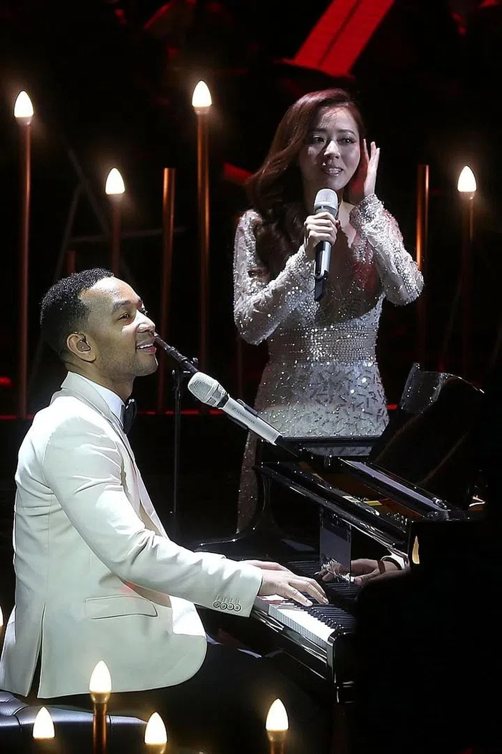 Zhang performing with John Legend in 2015. Photo: Getty 