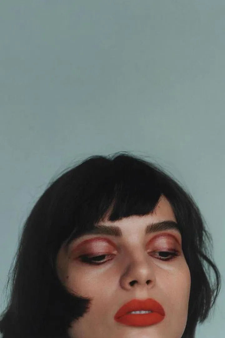 For a definitively un-old-fashioned act of daring, use a red in your crease, then again—mixed with something balmy—all over the lid. So now.