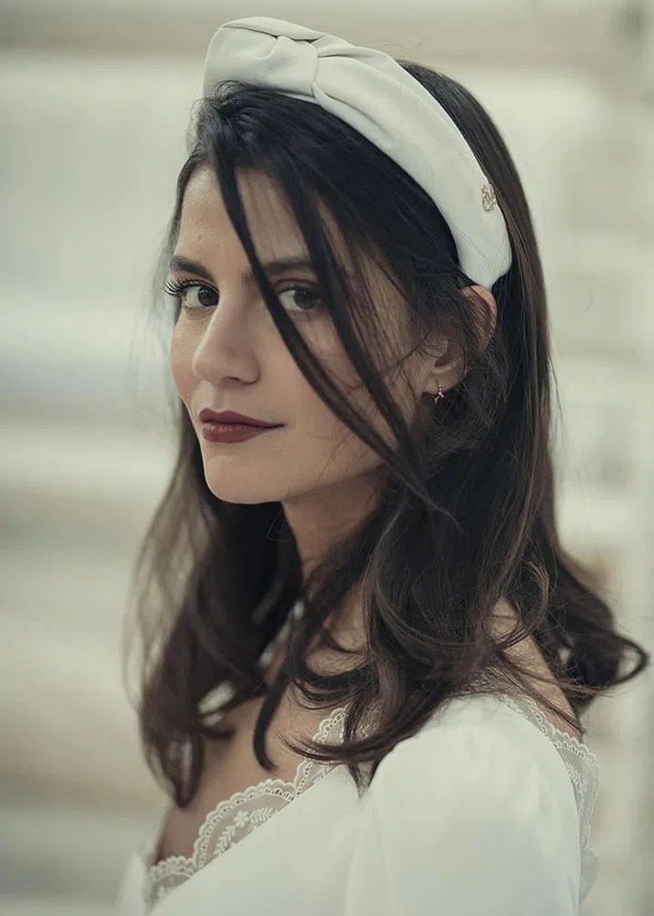 A berry-red lipstick and silk white headband (in lieu of a veil, of course) make a bouncy blowout look like the most innovative and original bridal hairstyle.