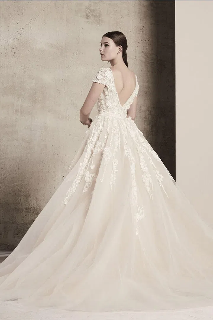 Cascading lace details and plunging backs will take guests' (and your groom's!) breath away during a sunset ceremony. Elie Saab gown, eliessab.com. 