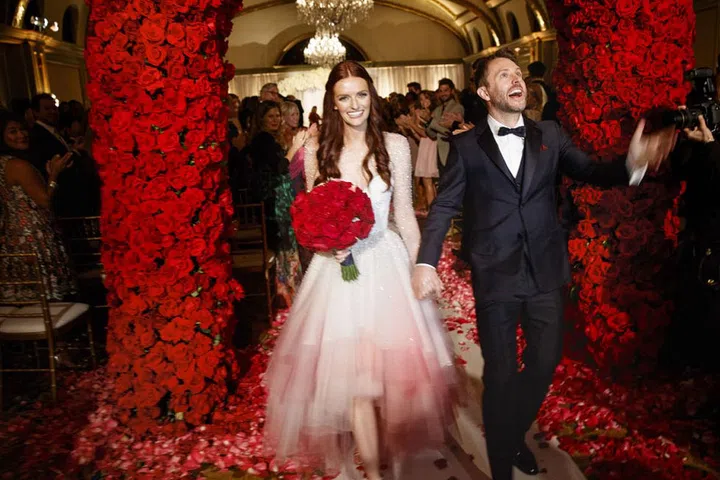 I love color! All of the aspects of the event ranged from light pink to a deep burgundy and of course, Tardis blue. Unique and special, just like my relationship with Chris. Rev. Edward Dumke (who married my mother and father) officiated the ceremony along with Jaime King." Photo: Lara Porzak