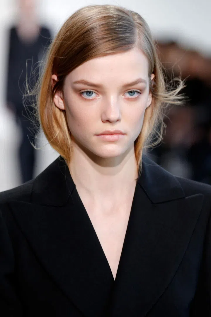 The beauty at Calvin Klein is always simple and wearable. This season was no different, with side-parted, shiny low ponytails and minimal, fresh-looking make-up.