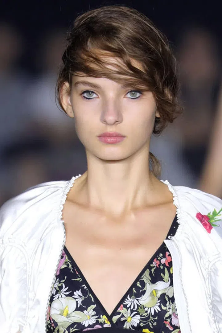 The Look: The Morning After Prom
How-To: The runway at 3.1 Phillip Lim was scattered with crushed flowers and dirt. It was meant to look like a dance had happened there the night before, a sort of Western-inspired high school prom. In beauty, that theme translated to sharp black eyeliner and a deconstructed, '60s- inspired low ponytail. Makeup artists traced a black liquid NARS eyeliner all around the eye, from the top to bottom lid. After filling in the waterlines with a kohl pencil, they used a Q-tip dipped in micellar water to wipe away the liner just at the edges of the eye. The effect was a sort of play on negative space, as if the girls had been dancing all night and their eyeliner just stayed put. Let's just say that it's the coolest prom(ish) beauty look we've seen lately.