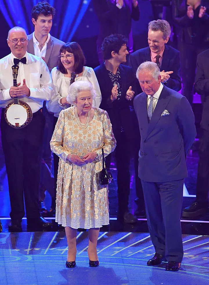 The Queen joins Prince Charles on stage.