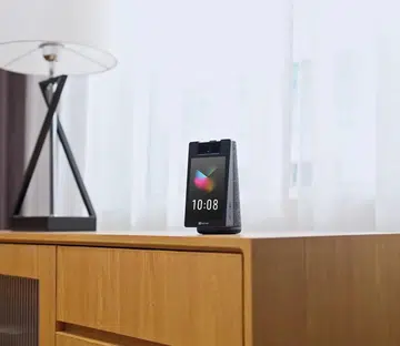 ezviz s10 smart home camera on a wooden cabinet in a modern living room